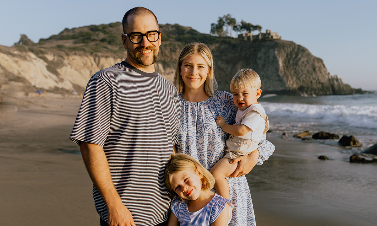 Stewart, Becky, Woodward, and Linden Tribe stand on a beach.